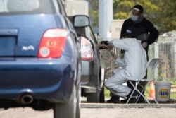 Medical professionals conduct tests for the coronavirus disease in Bolinas, a coastal area in Northern California where all residents are being tested for the novel coronavirus and its antibodies recently.