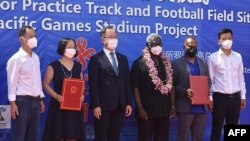 A photo taken on April 22, 2022, shows China's ambassador to the Solomon Islands, Li Ming, center left, and Solomons Prime Minister Manasseh Sogavare, center right, with other officials during the opening ceremony of a China-funded national sports stadium in Honiara.