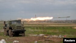 Service members of pro-Russian troops fire a BM-21 Grad multiple rocket launch system during fighting in Ukraine-Russia conflict near a plant of Azovstal Iron and Steel Works in the southern port city of Mariupol, Ukraine May 2, 2022.