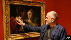 Ukrainian painter Oleksandr Roytburd views "An Amorous Couple" by 18th century French artist Pierre Louis Goudreaux in the Khanenko Family National Museum in Kyiv, Ukraine, Tuesday, July 14, 2020.