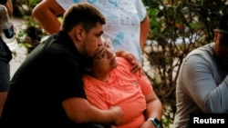 People react outside the Ssgt Willie de Leon Civic Center, where students had been transported from Robb Elementary School after a shooting, in Uvalde, Texas, U.S. May 24, 2022.
