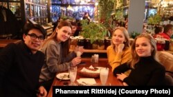 Phannawat Ritthidej (left) and Valeriia Golovakhina (second from left) meet with their friend in Kyiv, Ukraine in 2019