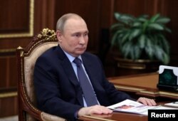 Russian President Vladimir Putin attends a meeting with CEO of Znanie Society Maxim Dreval in Moscow, Russia May 5, 2022.