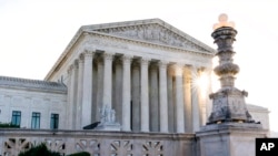 FILE - The sun rises behind the US Supreme Court in Washington, on Nov. 10, 2020. 