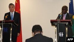 Chinese Foreign Minister Wang Yi and his counterpart from the Solomon Islands, Jeremiah Manele, attend a press conference in Honiara, May 26, 2022. China has "no intention at all" to build a military base in the Solomons, Wang said.