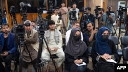 FILE - Afghan journalists attend a press conference led by Taliban's acting first deputy prime minister Abdul Ghani Baradar, not pictured, and other dignitaries in Kabul, May 24, 2022. The Taliban is suspected of blocking access to various online news sites in Afghanistan.