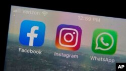 The mobile phone apps for, from left, Facebook, Instagram and WhatsApp are shown on a device in New York. (AP Photo/Richard Drew, File)