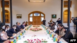 FILE - This handout photo released by the Taliban Foreign Ministry shows Taliban Foreign Minister Amir Khan Muttaqi, center right, meeting with China's Foreign Minister Wang Yi, center left, in Kabul on March 24, 2022