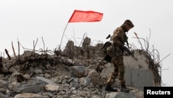 A serviceman of the self-proclaimed Donetsk People’s Republic (DNR) walks at the damaged war memorial complex Savur-Mohyla outside the rebel-held city of Donetsk, Ukraine September 7, 2018. REUTERS/Alexander Ermochenko