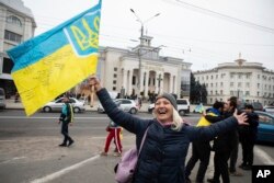 Ukrainians gather in downtown to celebrate the recapturing of their city Kherson, Ukraine, Saturday, Nov. 12, 2022.