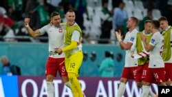 Poland's players celebrate at the end of the World Cup group C soccer match between Poland and Saudi Arabia, at the Education City Stadium in Al Rayyan , Qatar, Saturday, Nov. 26, 2022. 