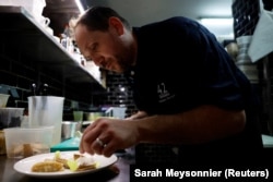 French chef Fabien Borgel prepares a dish of 'Faux-gras', a vegan alternative to foie gras, in his restaurant "42 degres" in Paris, France, December 15, 2022. (REUTERS/Sarah Meyssonnier)