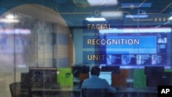 Employees work at the Facial Recognition Unit at the Hyderabad Police Headquarters in Hyderabad, India. (AP Photo/Mahesh Kumar A.)