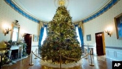 The White House Christmas Tree is on display in the Blue Room of the White House during a press preview of holiday decorations at the White House, Monday, Nov. 28, 2022, in Washington. (AP Photo/Patrick Semansky)