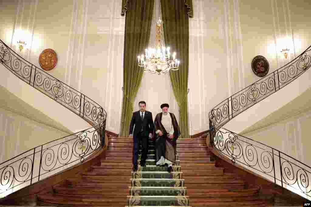 Iran's President Ebrahim Raisi, right, and Iraq's Prime Minister Mohamed Shia al-Sudani arrive for a joint press conference in the capital Tehran, in this handout picture provided by the Iranian presidency.