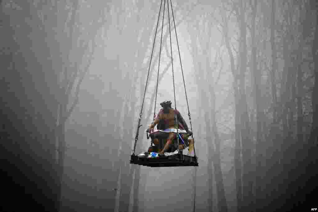The sculpted group Apollo on his Chariot is being lifted as part of the launch of the restoration of the basin of the Chariot of Appolo at the Versailles castle outside Paris, France.