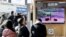 People watch a TV broadcasting a news report on North Korea firing a ballistic missile off its east coast, in Seoul, South Korea, Dec. 18, 2022. 