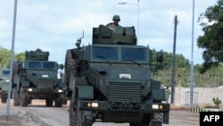 FILe - A Somalia National Army (SNA) soldier rides on an armored personnel carrier during celebrations on their 62nd anniversary in Mogadishu, Apr. 12, 2022. 