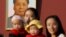 FILE - Two women and their babies pose for photographs in front of the giant portrait of late Chinese chairman Mao Zedong on the Tiananmen Gate in Beijing Nov. 2, 2015.