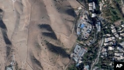 This satellite photo from Planet Labs PBC shows Evin prison in Tehran, Iran, Oct. 16, 2022, after a fire at the complex amid ongoing national protests. Iran's judiciary raised the death toll, Oct. 17, 2022, in a blaze at the prison, saying at least eight were killed.