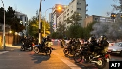FILE - A picture obtained by AFP outside Iran shows shows Iranian police on motorbikes during a protest in support of Mahsa Amini, a woman who died after being arrested by the Islamic republic's "morality police", in Tehran on Sept. 19, 2022.