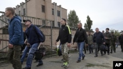 Reclutas rusos pasan frente a un centro de reclutamiento militar en Volgogrado, Rusia, el sábado 24 de septiembre de 2022. El presidente ruso, Vladimir Putin, ordenó el miércoles una movilización parcial de reservistas para reforzar sus fuerzas en Ucrania. (Foto AP, Archivo)