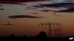 FILE - Power lines are seen at dawn, near Wernigerode, Saxony-Anhalt, Germany, Oct. 10, 2022.