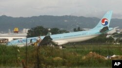 A damaged Korean Air plane lies after it overshot the runway at the Mactan-Cebu International Airport in Cebu, central Philippines early Oct. 24, 2022. The Korean Air plane overshot the runway while landing in bad weather in the central Philippines