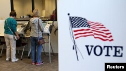 FILE - Voters cast ballots as early absentee voting began ahead of the U.S. presidential election in Medina, Cleveland, Ohio, Oct. 12, 2016. 