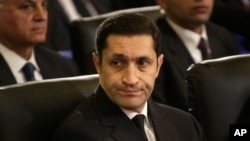 FILE - Alaa Mubarak, son of Egyptian President Hosni Mubarak, attends the Christmas Eve Mass at the Coptic cathedral in Cairo, Egypt, Jan. 6, 2011.