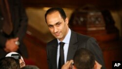 FILE - Gamal Mubarak, center, son of Egyptian President Hosni Mubarak, talks to guests prior to the speech of U.S. President Barack Obama at Cairo University in Cairo, Egypt, June 4, 2009.