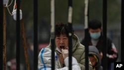A woman has her routine COVID-19 test at a coronavirus testing site setup inside a residential compound in Beijing, Thursday, Nov. 24, 2022. (AP Photo/Andy Wong, File)