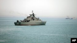 A woman sells "Happy New Year 2017" headwear on a shopping street in Sydney, Australia.