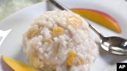 This Oct. 5, 2010 photo shows basmati-almond rice pudding with mango. The rich flavor of almond milk makes this rice pudding a wonderful non-dairy side. (AP Photo/Larry Crowe)