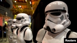Salespeople dress as Storm Trooper characters from "Star Wars" as merchandise goes on sale for the film "Star Wars: The Force Awakens" in Times Square in the Manhattan borough of New York.