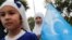 An ethnic Uyghur girl holds an East Turkestan flag during a protest against China, in Istanbul, Turkey Aug. 31, 2022. 