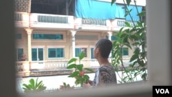 Oun Retra looked out as she stood on her house veranda, in Phnom Penh. Retra was diagnosed with colon cancer and she passed away in September, 2020. (Khan Sokummono/VOA Khmer)