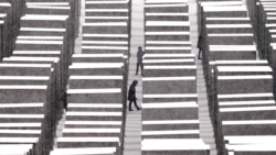 FILE - People visit the the Memorial for the Murdered Jews of Europe, the so-called Holocaust Memorial, during a snowfall in Berlin, Germany, Dec. 9, 2021.