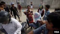 រូបឯកសារ៖ កម្មករ​រោងចក្រ​ដែល​រងរបួស​ម្នាក់ ត្រូវ​បាន​សហការី​ជួយ ក្រោយពី​ការប៉ះទង្គិច​គ្នា បាន​កើតឡើង​នៅ​ក្នុង​អំឡុង​ពេល​បាតុកម្ម​ក្នុង​ទីក្រុង​ភ្នំពេញ នៅ​ថ្ងៃទី ៣ ខែមករា ឆ្នាំ២០១៤។