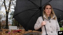 FILE - Claire Tillberg, stands for a portrait outside her family's home, Monday, Nov. 23, 2020, in a Boston suburb. Her 11-year-old daughter has been hospitalized twice after sharing that she was having suicidal thoughts.