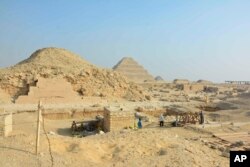 This photo provided by the Saqqara Saite Tombs Project in January 2023 shows an excavation area overlooking the pyramid of Unas and the step pyramid of Djoser in Saqqara, Egypt. (Susanne Beck/Saqqara Saite Tombs Project, University of Tübingen via AP)