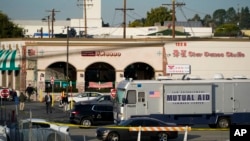 Investigators are seen outside Star Dance Studio in Monterey Park, Calif., Sunday, Jan. 22, 2023. (AP Photo/Jae C. Hong)
