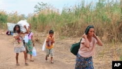 Displaced people from Myanmar along the Thai side of the Moei River in Mae Sot, Thailand on Feb. 5, 2022. (AP Photo)