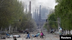 Smoke rises above a plant of Azovstal Iron and Steel Works in Mariupol