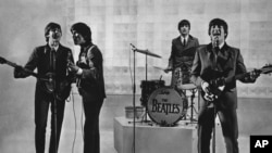 FILE - The Beatles are seen performing, date unknown. From left to right: Paul McCartney, George Harrison, Ringo Starr, and John Lennon. (AP Photo)