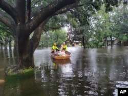 In this photo provided by the Orange County Fire Rescue's Public Information Office, firefighters in Orange County, Fla., help people stranded by Hurricane Ian early Thursday, Sept. 29, 2022.