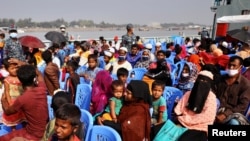 FILE - Rohingyas sit onboard a ship as they move to Bhasan Char island near Chattogram, Bangladesh, Dec. 4, 2020. 