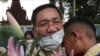 Thach Setha, vice president of the country's main opposition Candlelight Party, hugs a boy in front of the Prey Sar main prison outside Phnom Penh, Cambodia, on November 10, 2021. (Heng Sinith/AP)