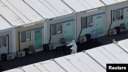 A worker wears personal protective equipment at a COVID-19 isolation facility in Tsing Yi, during the COVID-19 pandemic in Hong Kong, China, March 8, 2022.