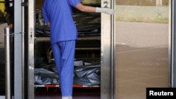 FILE - Corpses are seen at a hospital’s bereavement room, as COVID-19 cases surge in Hong Kong, China, March 3, 2022.